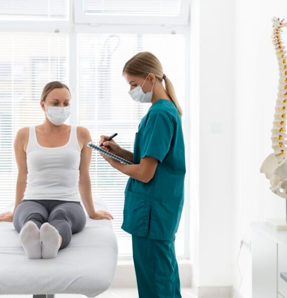 young-physiotherapist-helping-patient-with-back-problems